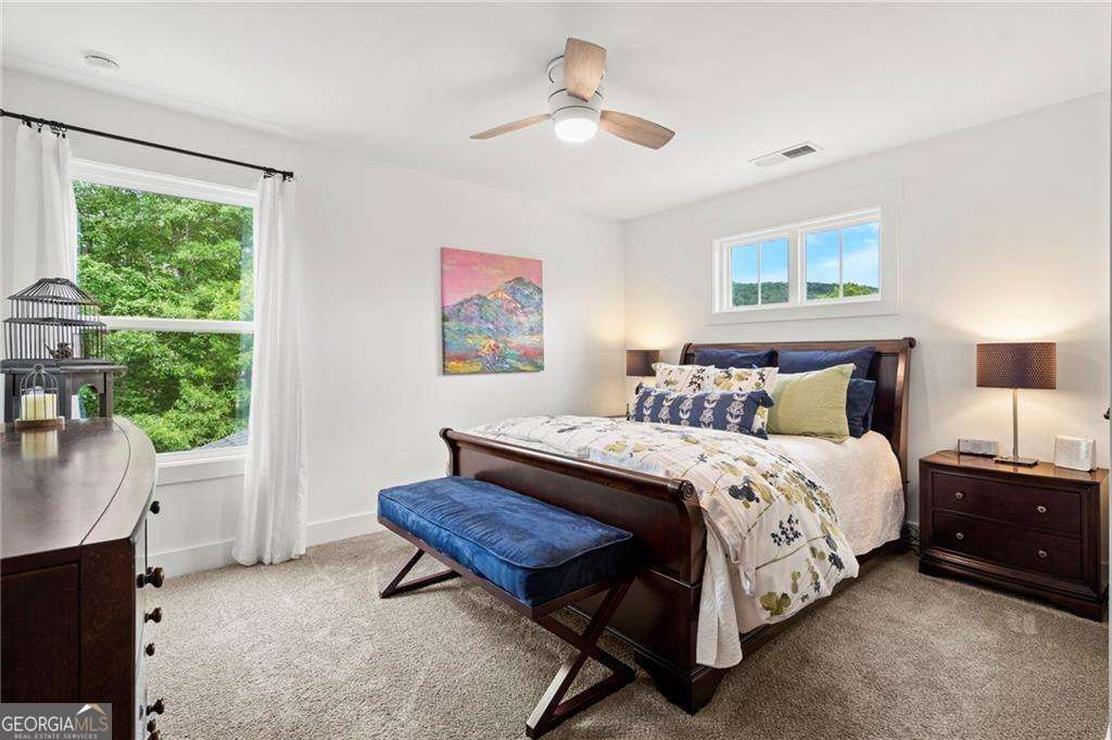 175 STONELEDGE Trace North Jasper, GA 30143 - Photo 21 of 31 a spacious bedroom with a bed a couch and a window