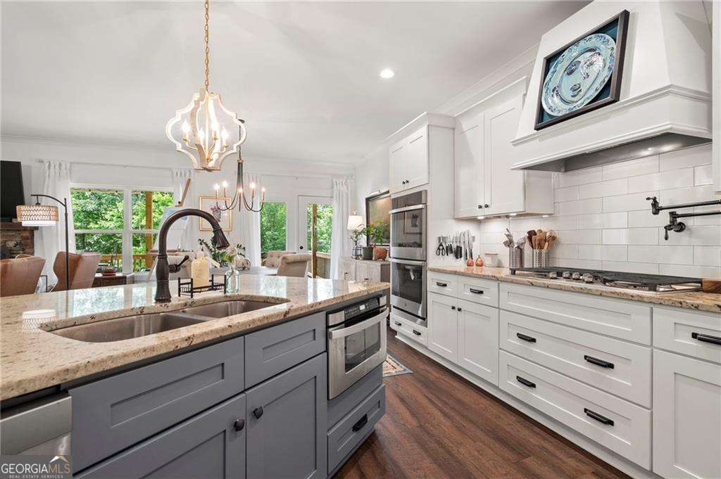 175 STONELEDGE Trace North Jasper, GA 30143 - Photo 8 of 31 a kitchen with granite countertop stainless steel appliances a sink and cabinets