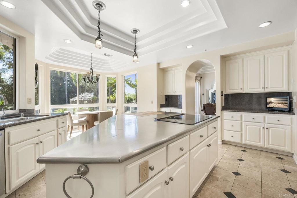 15615 Boulder Ridge Lane Poway, CA 92064 - Photo 11 of 75 a kitchen with stainless steel appliances granite countertop a sink a stove counter space and living room view