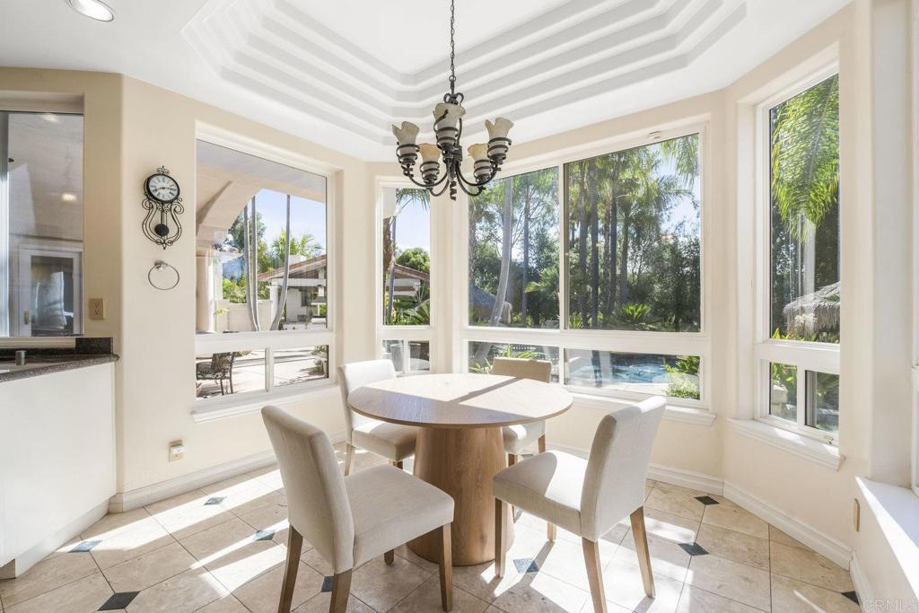 15615 Boulder Ridge Lane Poway, CA 92064 - Photo 12 of 75 a view of a dining room with furniture large windows and wooden floor