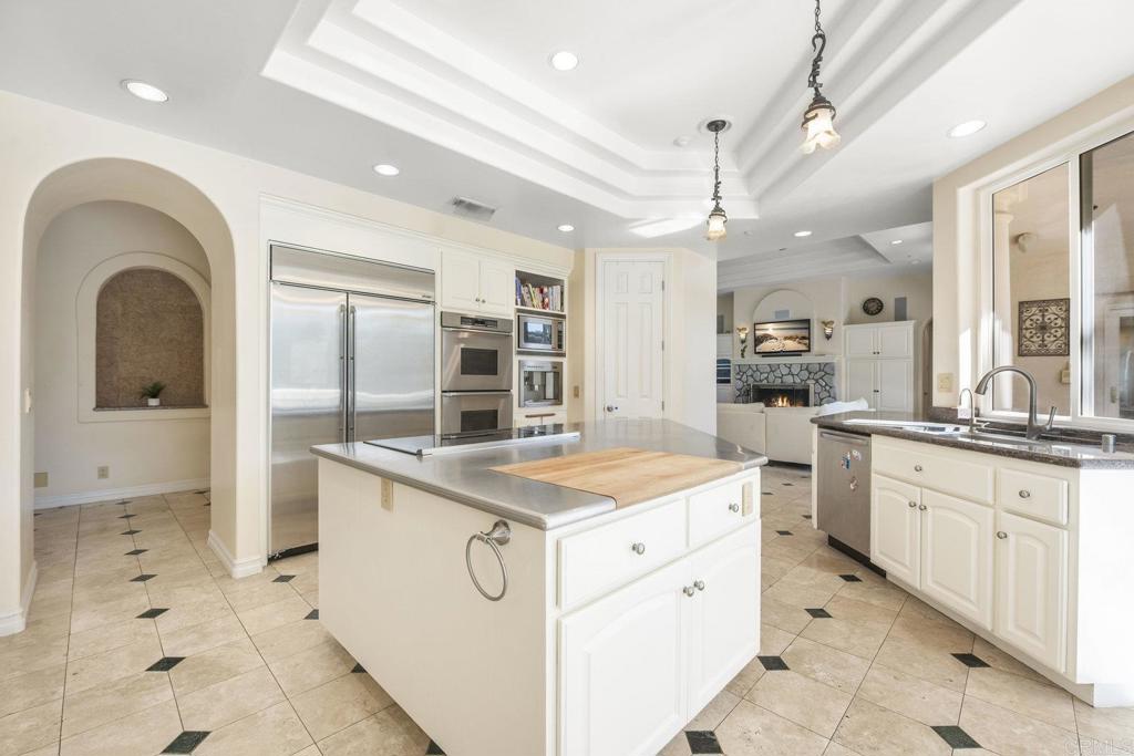15615 Boulder Ridge Lane Poway, CA 92064 - Photo 13 of 75 a large white kitchen with a stove a sink a refrigerator and chandelier