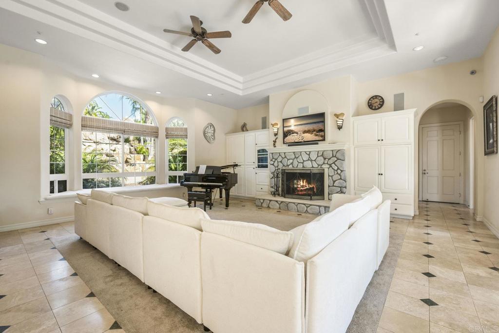 15615 Boulder Ridge Lane Poway, CA 92064 - Photo 15 of 75 a living room with furniture a fireplace and a flat screen tv
