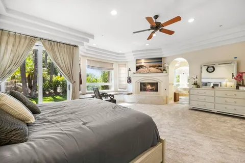 a spacious bedroom with a bed and a window