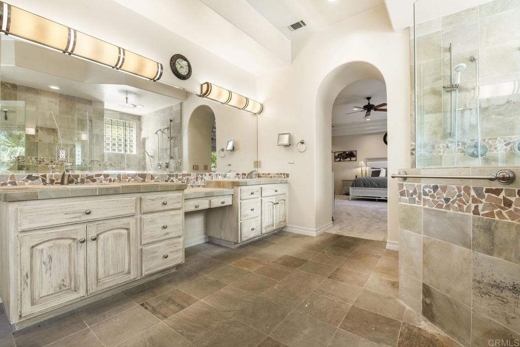 15615 Boulder Ridge Lane Poway, CA 92064 - Photo 24 of 75 a spacious bathroom with a granite countertop sink a mirror and a