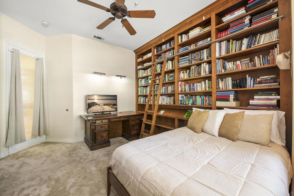 15615 Boulder Ridge Lane Poway, CA 92064 - Photo 28 of 75 a bedroom with a bed and a book shelf