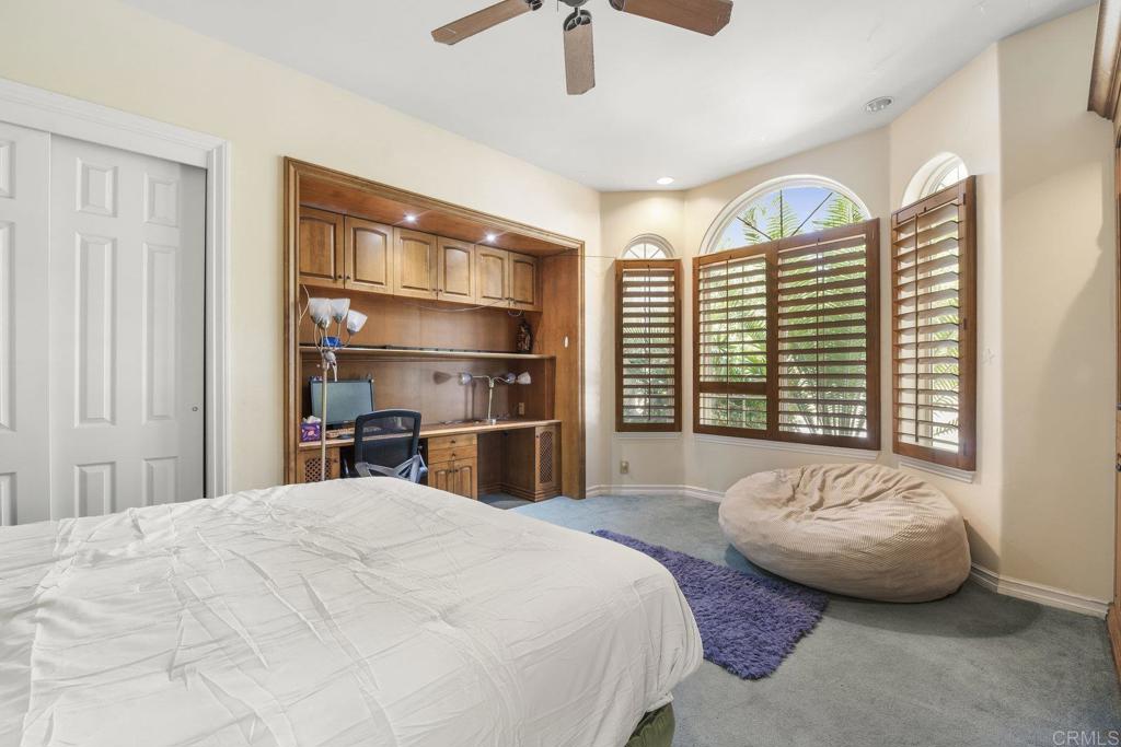 15615 Boulder Ridge Lane Poway, CA 92064 - Photo 32 of 75 a bedroom with a bed and a chandelier