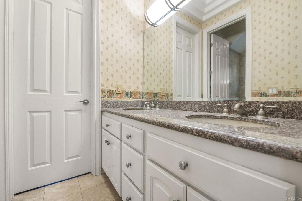 15615 Boulder Ridge Lane Poway, CA 92064 - Photo 33 of 75 a bathroom with a granite countertop sink and a mirror