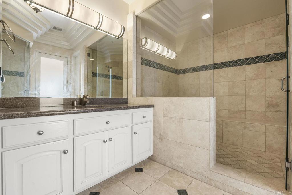 15615 Boulder Ridge Lane Poway, CA 92064 - Photo 34 of 75 a bathroom with a granite countertop sink a mirror and shower