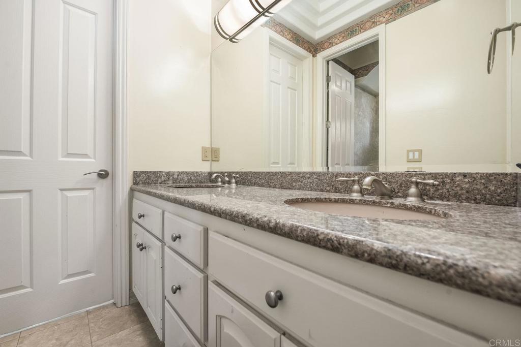 15615 Boulder Ridge Lane Poway, CA 92064 - Photo 36 of 75 a bathroom with a granite countertop sink and a mirror