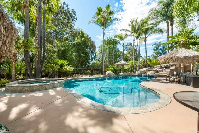 a kitchen with white cabinets appliances a sink and a window
