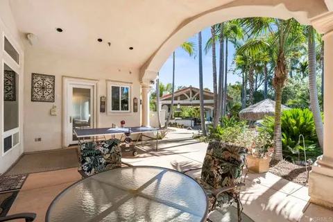 a bedroom with a bed a chair and a chandelier