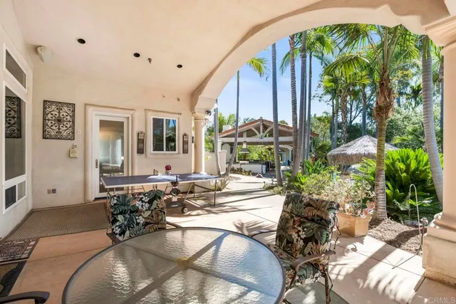 a bedroom with a bed a chair and a chandelier