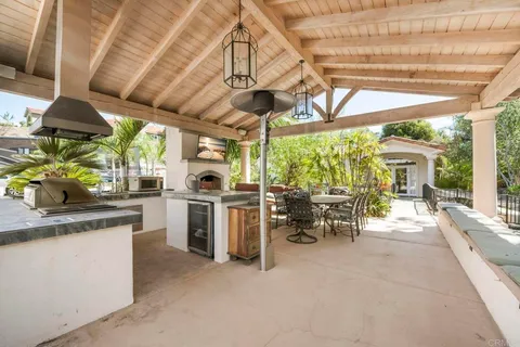 a view of a house with a backyard porch and sitting area