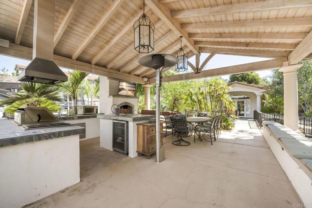 15615 Boulder Ridge Lane Poway, CA 92064 - Photo 41 of 75 a kitchen with sink cabinets and outdoor seating