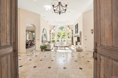 a view of a dining room with furniture large windows and wooden floor