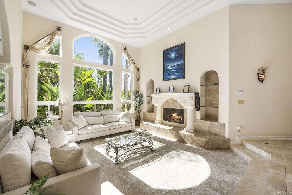 15615 Boulder Ridge Lane Poway, CA 92064 - Photo 6 of 75 a living room with furniture a fireplace and floor to ceiling windows