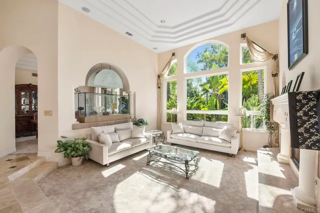 a kitchen with stainless steel appliances granite countertop a sink a stove counter space and living room view