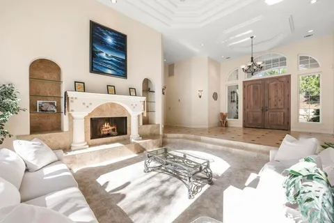 a view of a dining room with furniture large windows and wooden floor