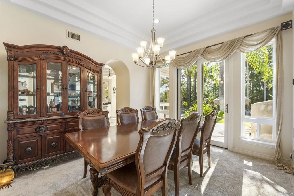15615 Boulder Ridge Lane Poway, CA 92064 - Photo 9 of 75 a view of a dining room with furniture large windows and wooden floor