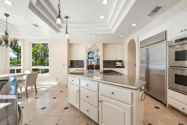 a large white kitchen with a large window