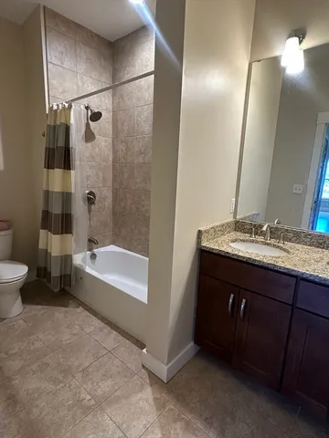 a bathroom with a double vanity sink toilet and shower