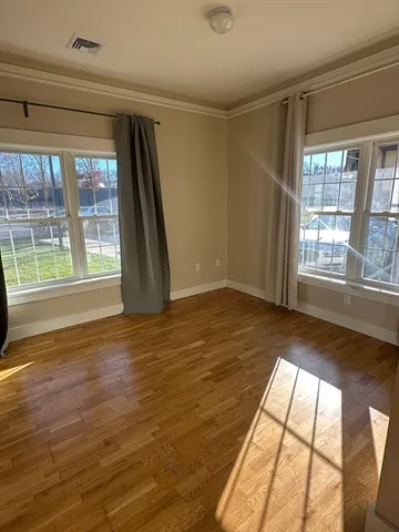 a view of an empty room and a window