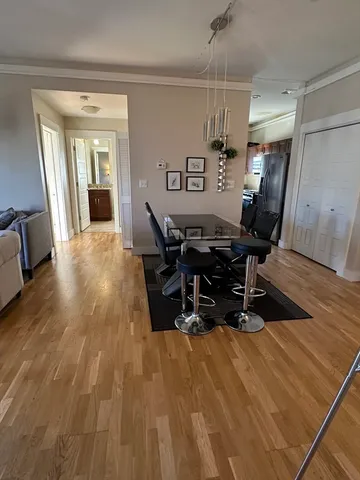 a workspace room with wooden floor and furniture