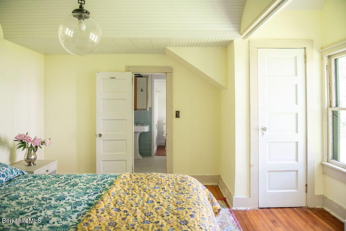 9 Yale Hill Road Stockbridge, MA 01262 - Photo 15 of 29 a bedroom with a bed and a chandelier