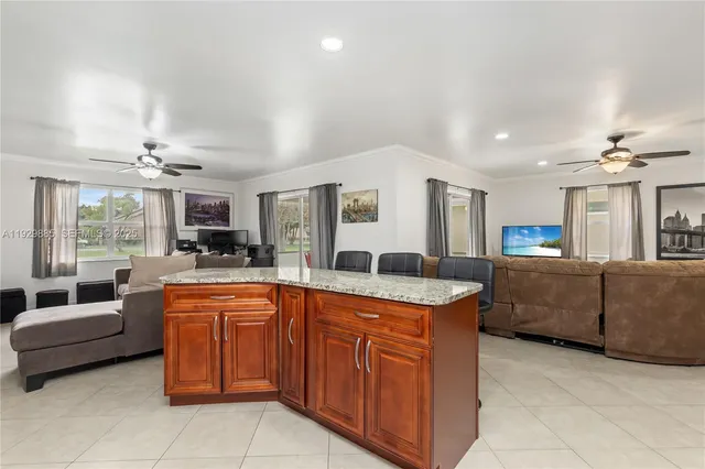 a living room with furniture a chandelier and a window