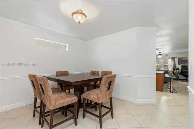 a bedroom with a bed a dresser and wooden floor