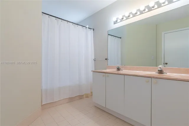 a bathroom with a granite countertop sink a toilet and shower