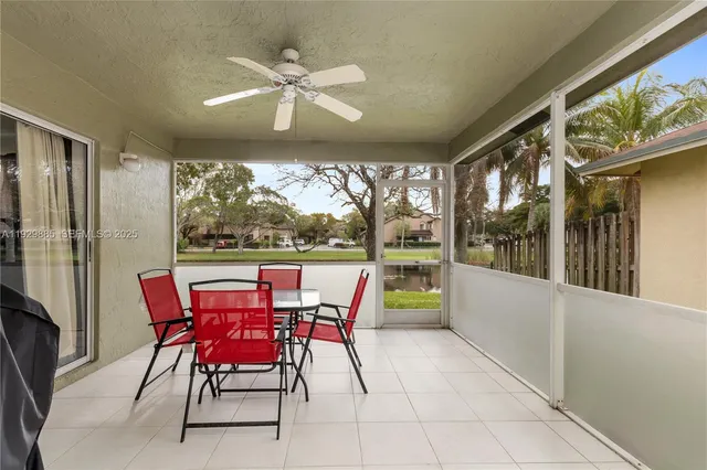 a view of a lake with a yard and large trees