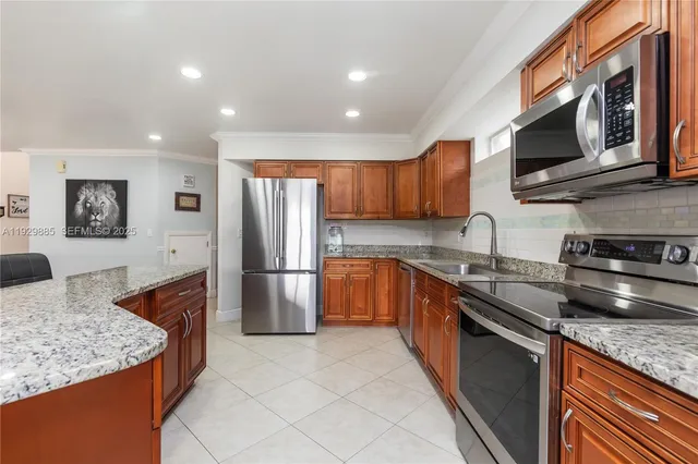 a kitchen with stainless steel appliances granite countertop a sink stove and microwave