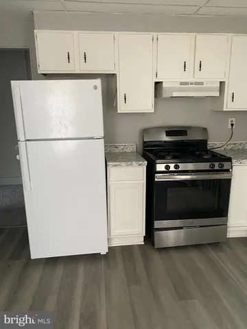 a white refrigerator freezer sitting inside of a kitchen