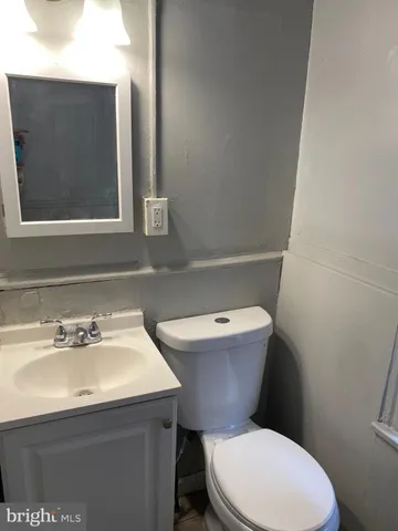 a white toilet sitting next to a bathroom sink