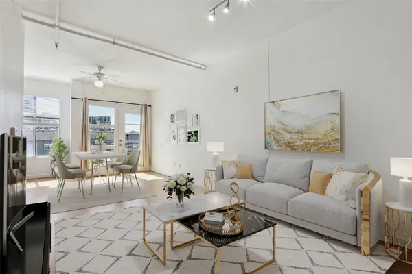 a living room with furniture and wooden floor
