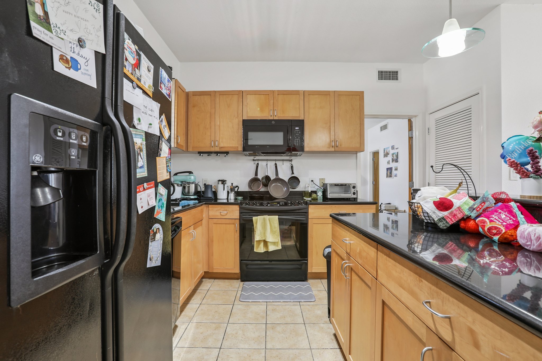 711 West 26th Street, Unit 704 Austin, TX 78705 - Photo 15 of 32 a kitchen with stainless steel appliances granite countertop a refrigerator a stove top oven a sink and dishwasher
