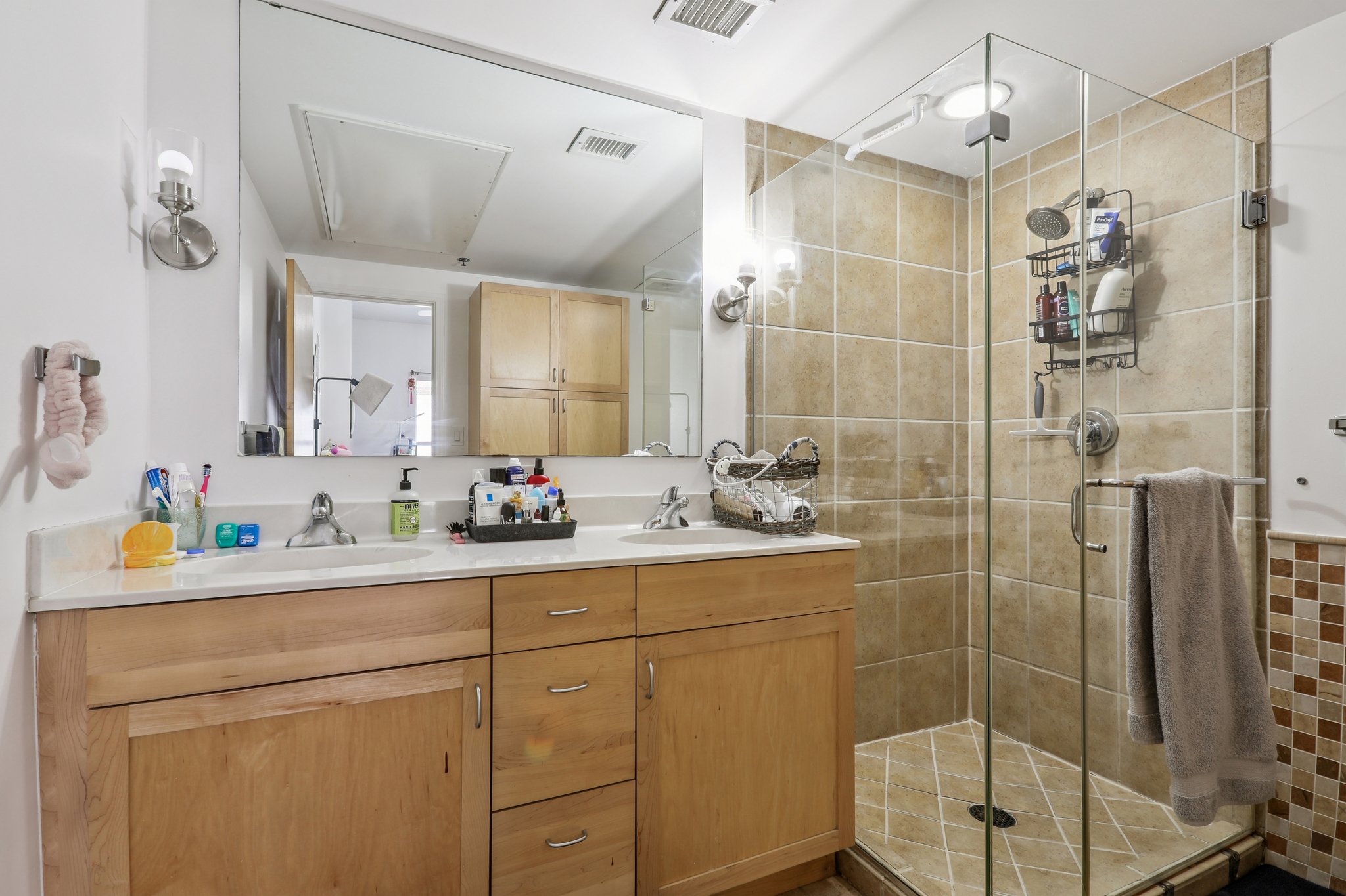 711 West 26th Street, Unit 704 Austin, TX 78705 - Photo 20 of 32 a bathroom with a shower sink and mirror