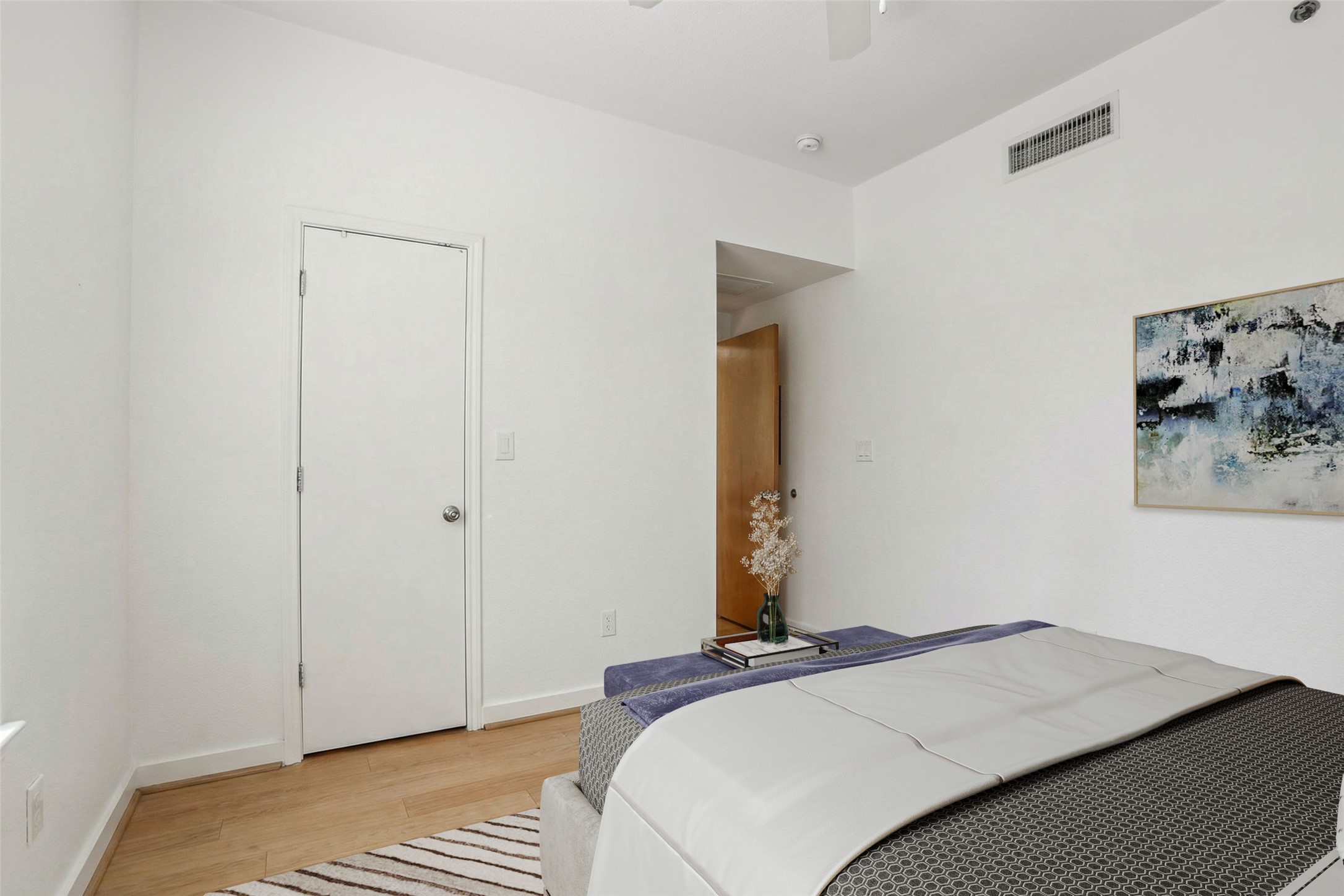 711 West 26th Street, Unit 704 Austin, TX 78705 - Photo 6 of 32 a bedroom with a bed and a painting on the wall