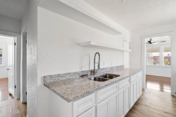 a kitchen with sink and refrigerator