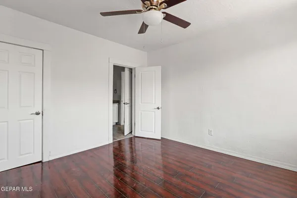 a view of an empty room with wooden floor