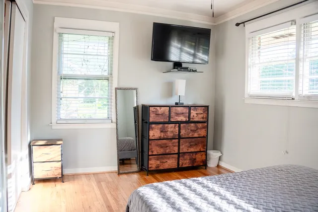 a bedroom with a bed and flat screen tv