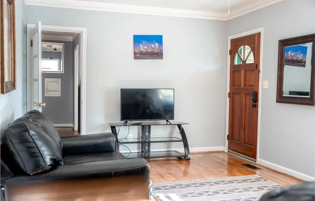 a living room with furniture and a flat screen tv