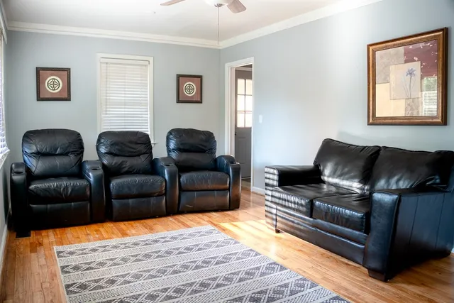 a living room with furniture and a wooden floor