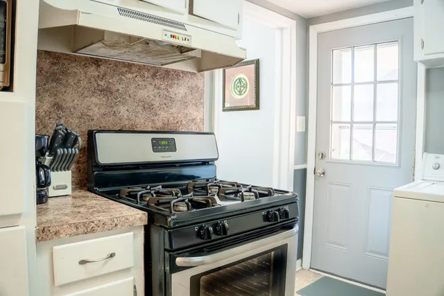 a kitchen with a stove and cabinets