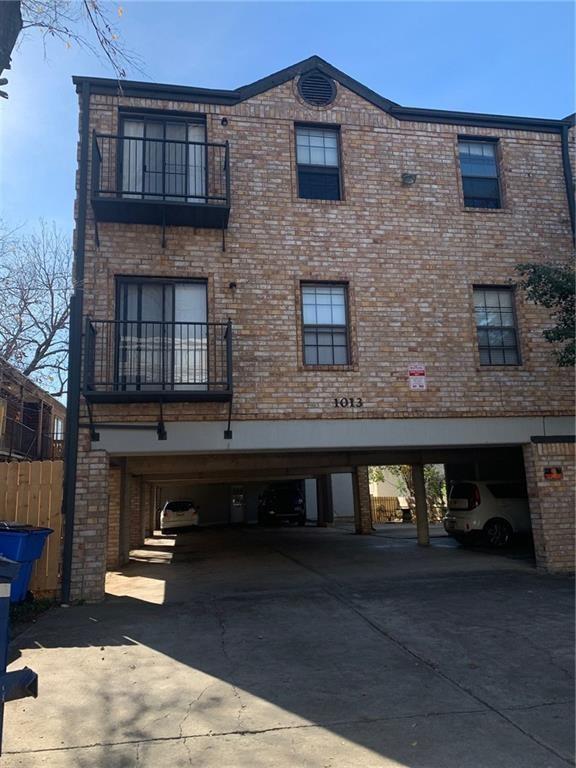 1013 West 23rd Street, Unit 201 Austin, TX 78705 - Photo 6 of 6 View of building exterior with a carport and concrete driveway