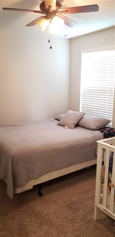 a bedroom with a bed and a table