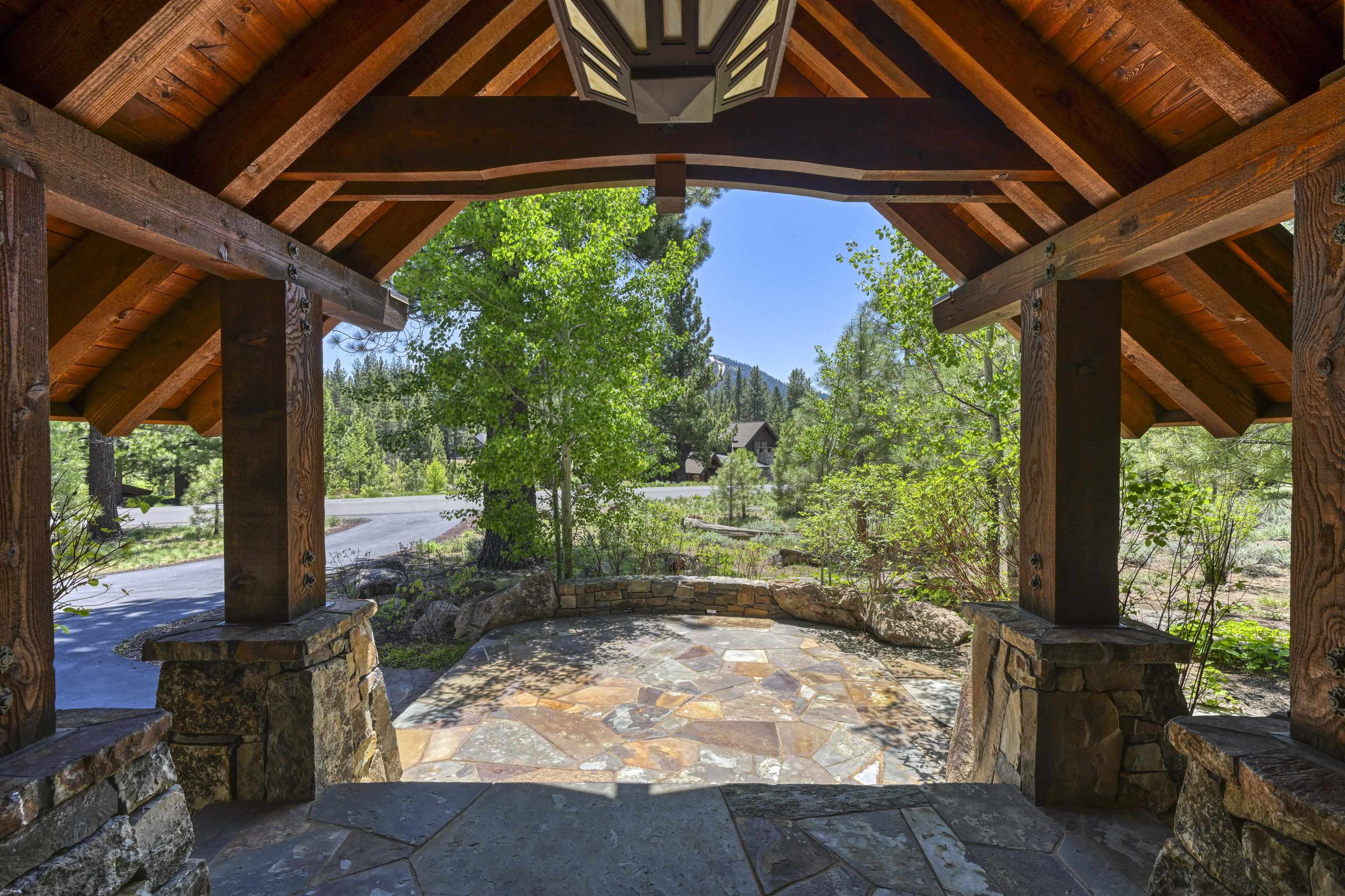 13123 Snowshoe Thompson Circle Truckee, CA 96161 - Photo 3 of 23 a view of a backyard with table and chairs under an umbrella