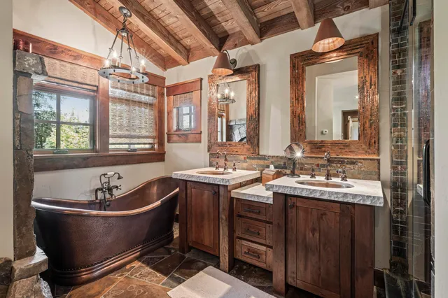 a bathroom with a bathtub sink and mirror