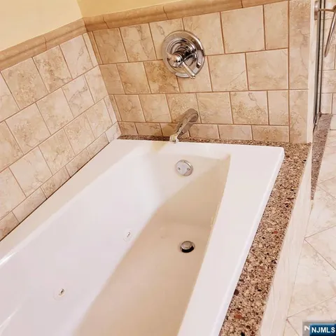 a bathroom with a bathtub and shower